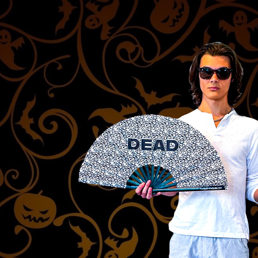 Man holding a Halloween hand fan at a rave and circuit party - The Gay Fan Club